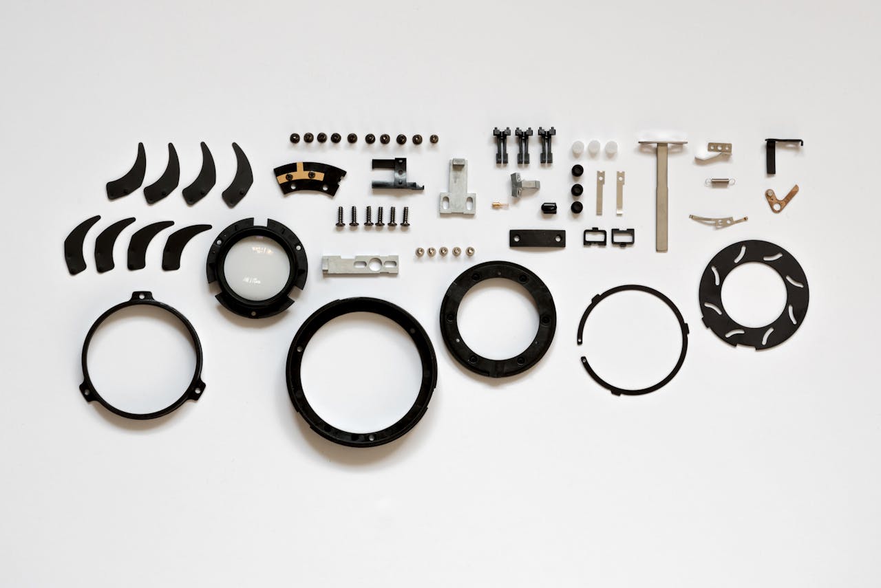 Organized layout of mechanical parts on a white surface, ideal for tech and engineering themes.
